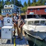 Washington State Parks/Contributed photo                                (From left to right): Owners Terri and Steve Mason and employees Nick Burne and Jonathan Hogue stand by the new pumpout facility located at the Shaw Island General Store.