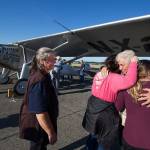 As his wife Heather looks on, John Norman gets a hug from his daughter Amber Nelson, and granddaughter Ashlee Nelson, right, after his replica of the Spirit of St. Louis flew for the first time from Arlington Municipal Airport on Sunday, July 28, 2019 in Arlington, Wash. (Andy Bronson / The Herald)