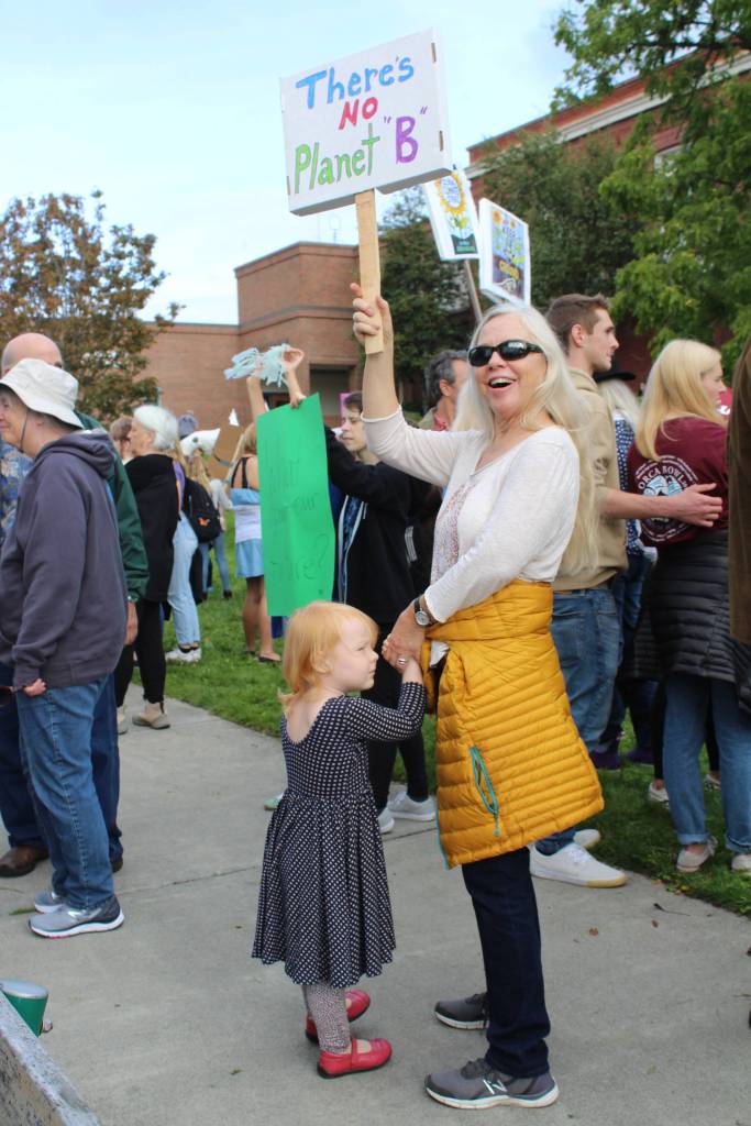 Islander Lisa Lawrence her grandchild show support for the environment. <em>(Heather Spaulding/staff photo)</em>