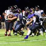 Gavin Mason, No. 54, and teammates stop the Wolves ball carrier.<em> (John Stimpson/Contributed photo)</em>