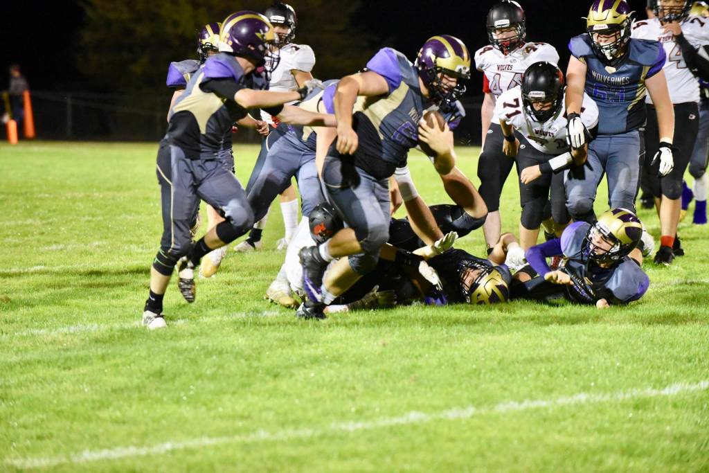 Ty Vague, No. 65 strip,s the ball from the Wolves ball carrier and runs for a touchdown. <em>(John Stimpson/Contributed photo)</em>