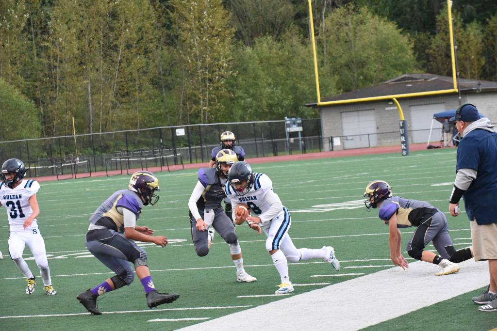 Wolverines Brian Wolf, 26, and Jaden Jones, 10, close in on the Turks running back and knock him out of bounds. <em>(John Stimpson/contributed photo)</em>