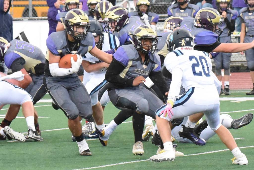Kadan Ritchie, No. 32, rushes for more yardage while Mateo Blackmon, No. 43, helps clear a path thru the defense. <em>(John Stimpson/contributed photo) </em>