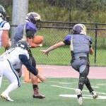 Wolverine Austin Wynne, No. 55, picks up a Turks fumble and scrambles into the endzone amidst the rain downpour. <em>(John Stimpson/contributed photo)</em>
