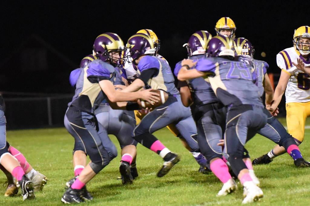 Quarterback Dylan Roberson, No. 7, hands off to Connor Haines, No. 29, for a run up the middle. (John Stimpson/Contributed photo)