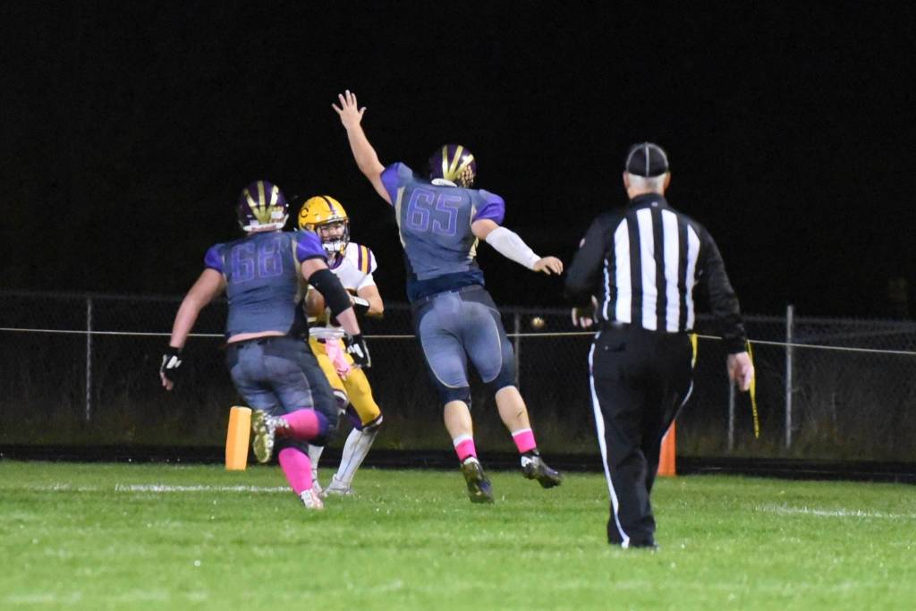 Weston Swirtz, No. 68, and Ty Vague, No. 65, rush the Lions passer. (John Stimpson/Contributed photo)