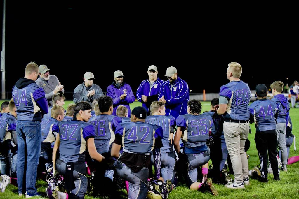 Victorious Wolverines get applauded by the coaching staff. (John Stimpson/Contributed photo)