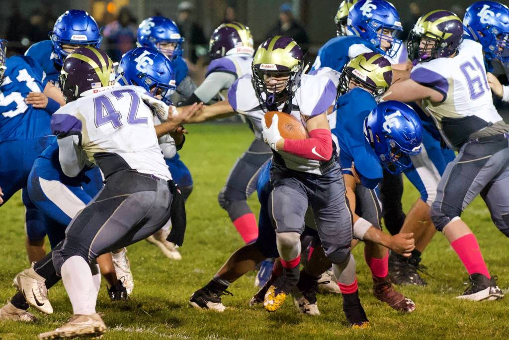 Kyson Jackson, No. 22, busts through the line on a good yardage gain. (John Stimpson/Contributed photo)