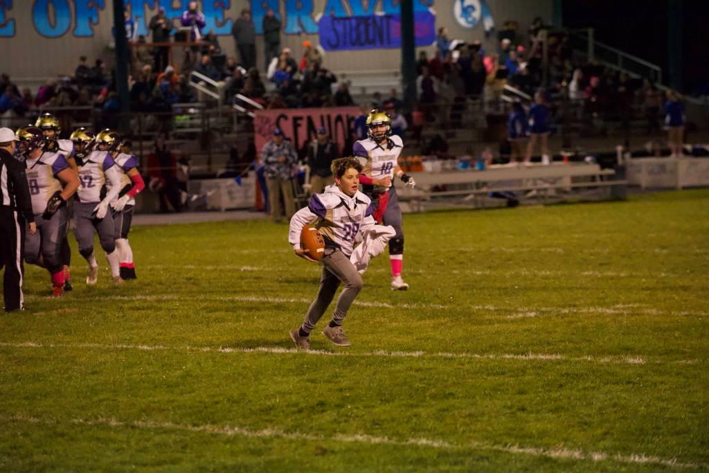 Ball boy Matthew Wolf kept a dry ball on the field during the Wolverines offensive play. (John Stimpson/Contributed photo)