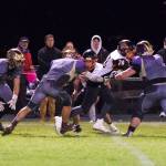 Wolverines Ty Vague, No. 65, and Weston Swirtz, No. 68, put the stop on the Tigers running back. (John Stimpson/contributed photo)
