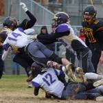 #12 Jaxson Waldron and #14 Jordan Lawson put a stop on a Raider ball carrier. (John Stimpson/Contributed photo.)