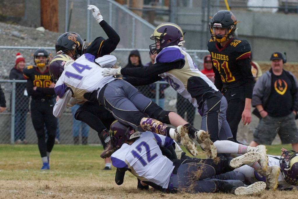 #12 Jaxson Waldron and #14 Jordan Lawson put a stop on a Raider ball carrier. (John Stimpson/Contributed photo.)