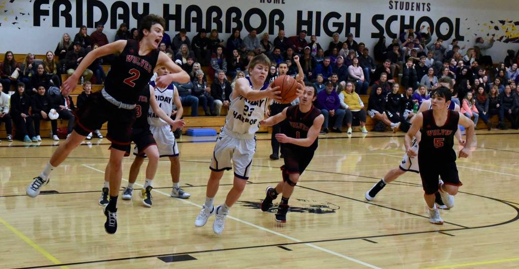 Dylan Roberson secures a rebound in the final seconds of the game dousing the Wolves chances for a score. (John Stimpson/contributed photo)