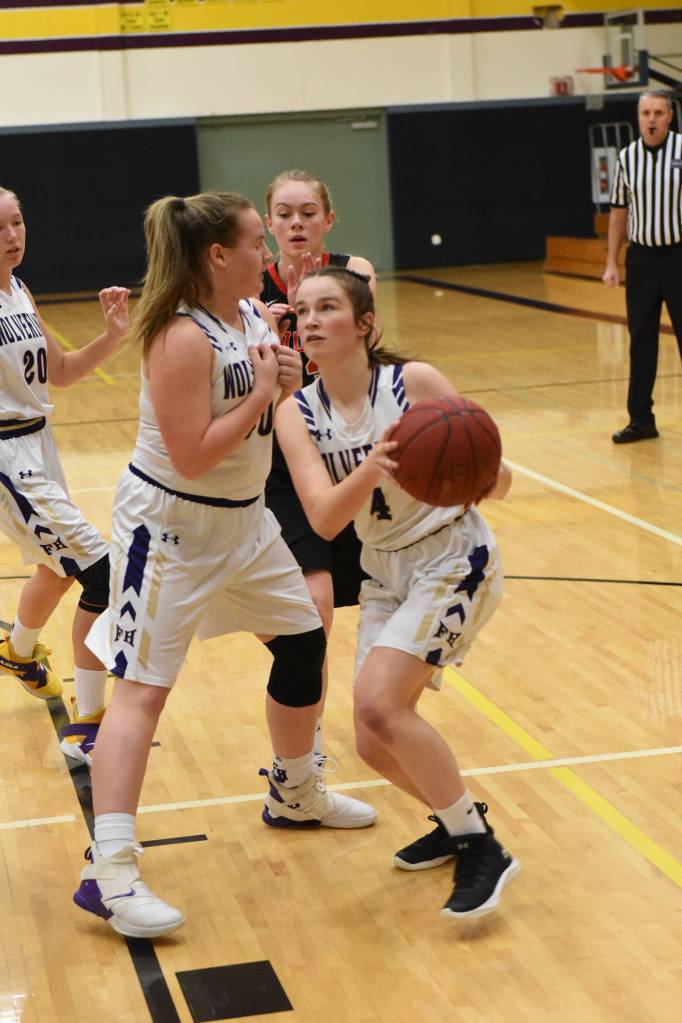 Ella Mason blocks Wolves defender allowing Fallon Taylor to drive to the basket. (John Stimpson/contributed photo)