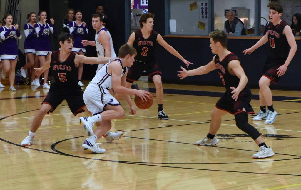 Dylan Roberson drives to the basket amidst heavy Wolves defensive pressure. (John Stimpson/contributed photo)