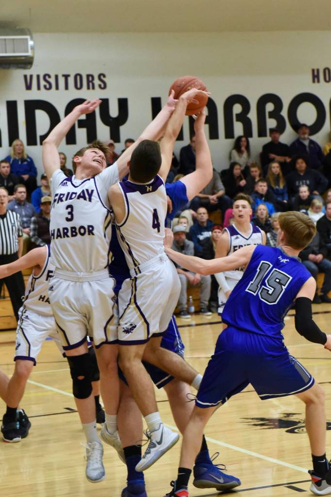 Remy August and Ty Anderson go for the rebound. (John Stimpson contributed photo.)