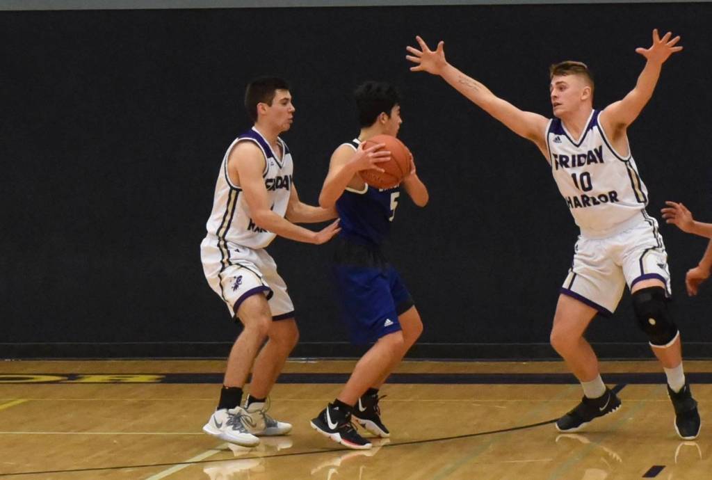 JJ Jones and Ty Anderson apply defensive pressure. (John Stimpson/contributed photo)