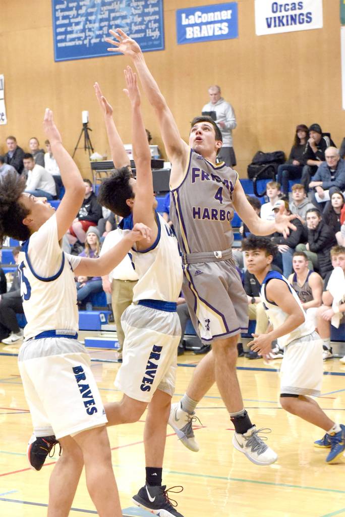 Ty Anderson keeps his cool under pressure from the Braves and shoots for two points from the base line. (John Stimpson/contributed photo.)