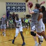 Remy August makes a two-point lay up under Falcon defensive pressure. (John Stimpson/contributed photo)