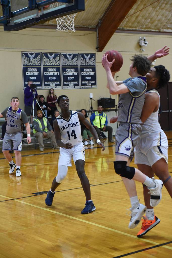 Remy August makes a two-point lay up under Falcon defensive pressure. (John Stimpson/contributed photo)