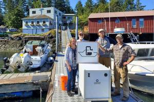 Shaw Island General Store owners Terri and Steve Mason and employees Nick Burne and Jonathan Hogue stand by the pumpout facility that was installed last summer. (Contribute photo)