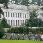 National Guard members march near a perimeter fence Sunday at the Capitol in Olympia. (AP Photo/Ted S. Warren)