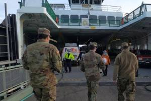Three National Guard members board the Tillikum during a previous visit to San Juan Countyto help distribute COVID vaccines in early 2021. (<a href="http://www.army.mil" target="_blank">www.army.mil</a> photo)