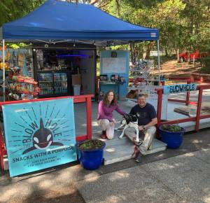 Contributed photo/New owners Vicki Edwards and Paul Rudd with Huckleberry the dog, offer new food items and a big new attitude at the Blow Hole at Lime Kiln Point State Park.