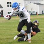Wolverine Geoffry Volk, #54, tackles Falcon running back in the backfield. (John Stimpson photo)