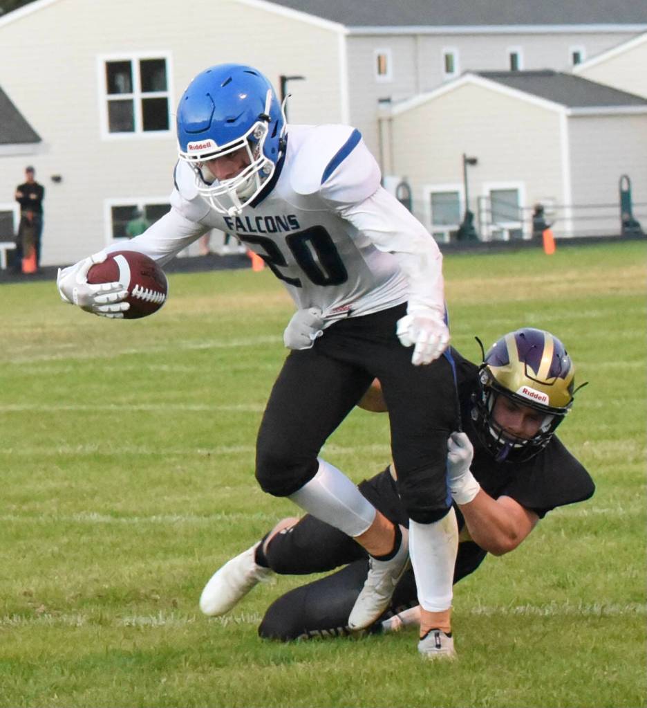 Wolverine Geoffry Volk, #54, tackles Falcon running back in the backfield. (John Stimpson photo)
