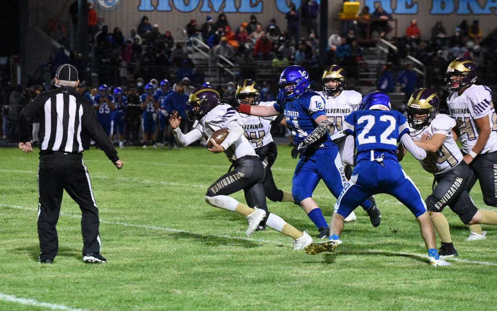 Wolverine Connor Haines, #14, picks up speed on the way to the goal line. (John Stimpson photo)