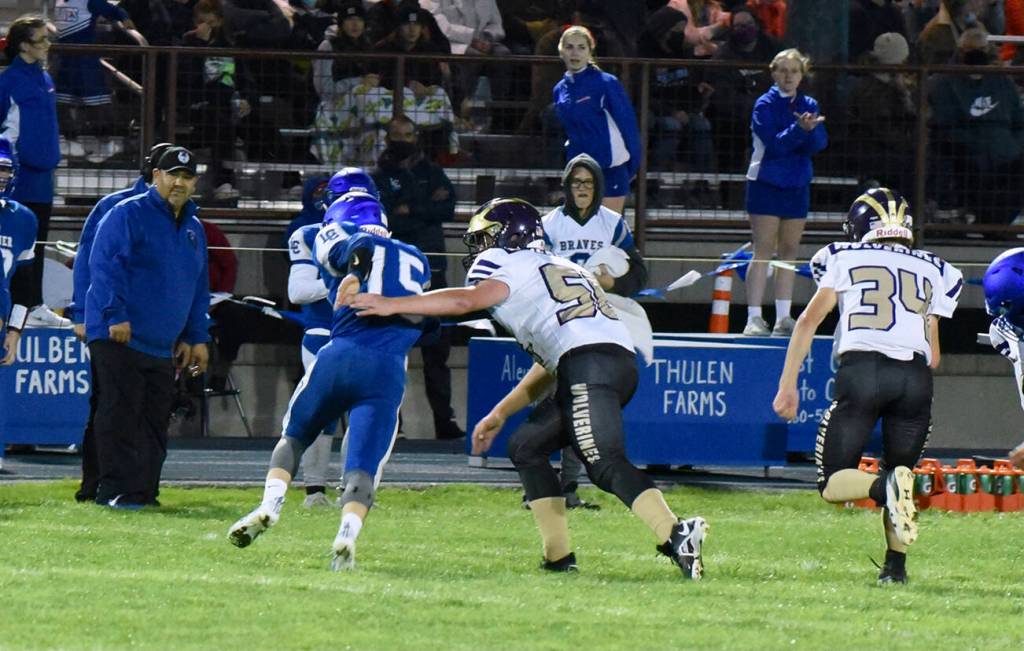 Wolverines Jack Mason, #56, and Whiley McCutcheon, #34, chase down the Braves quarterback. (John Stimpson photo)