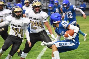 Connor Haines, #14, and Chris Gustafson, #24, to stop the La Connor Braves in their tracks. (John Stimpson photo)
