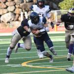 Wolverine Chris Gustafson, #24, wraps up the Cougar running back. (John Stimpson photo)