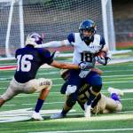Wolverines Geoffrey Volk, #54, and Graham Learing, #16, stop Cougars running back. (John Stimpson photo)