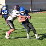 Wolverine Max Field, #65, forces Falcon running back out of bounds. (John Stimpson photo)