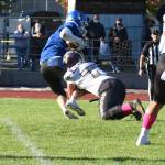 Wolverine Tate Geiser, #77, drops Falcon running back in the back field. (John Stimpson photo)