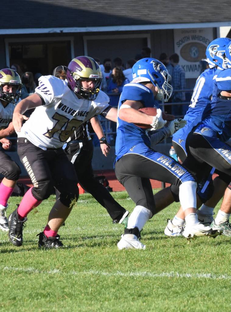 Wolverine TJ Ehresmann, #70, prepares to stop Falcon runningback. (John Stimpson)