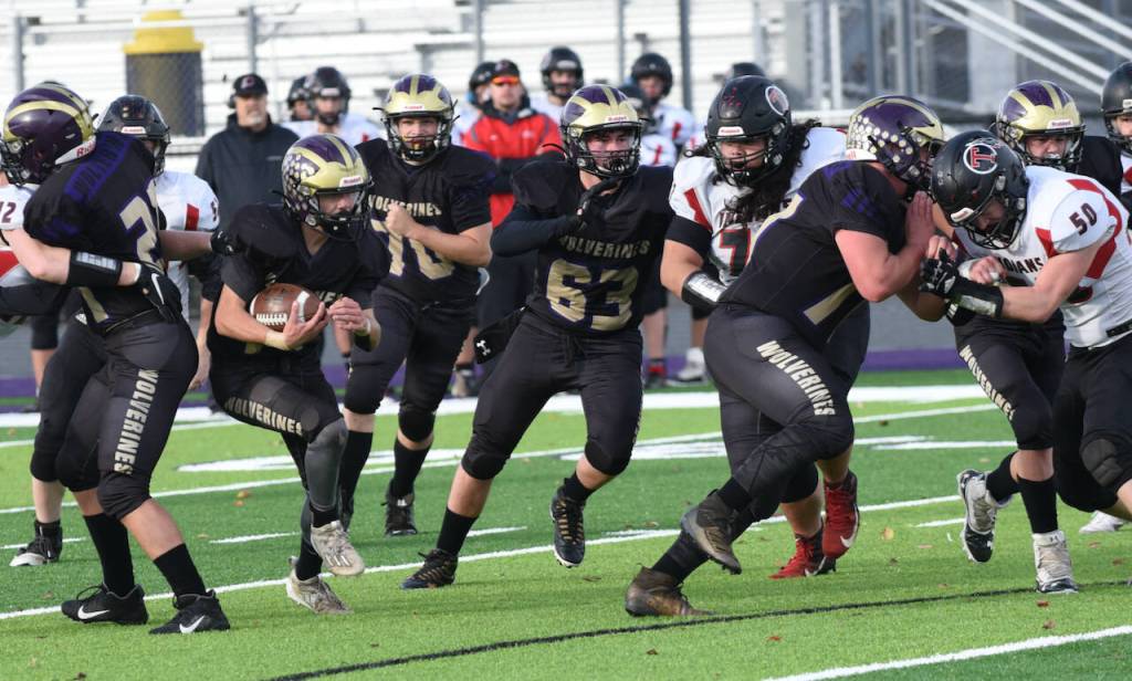 John Stimpson photo
Tate Geiser #77 and Gavin Garcia #63 clear a path for Connon Haines #14.