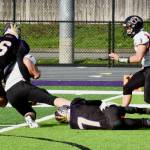 Dylan Roberson #7 and Graham Learing #16 tackle a Toledo runner