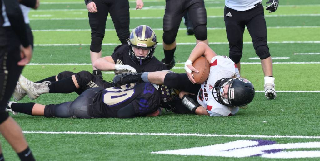 John Stimpson photo
Pierce Kleine and Geoffrey Volk#54 bring down Toledo runner.