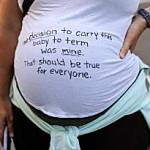 A pregnant protester is pictured with a message on her shirt in support of abortion rights during a march, Friday in Seattle. The U.S. Supreme Courts decision to end constitutional protections for abortion has cleared the way for states to impose bans and restrictions on abortion; and will set off a series of legal battles. (Stephen Brashear / Associated Press)