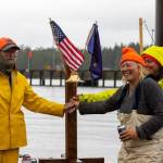 Team Sockeye Voyages captain John Calogero, along with Tara Watkins and Olivia Lord, ring the finish line bell, officially ending the 2022 R2AK Race To Alaska.