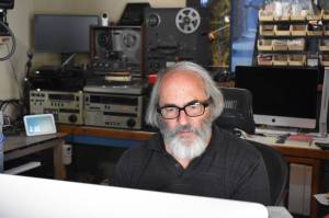Kelley Balcomb-Bartok/Staff Photo
Technowizard Steven K Roberts at his desk processing digital files recently scanned into the computer.