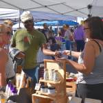 Shoppers in search of creative gifts enjoy the San Juan Summer Arts Festival.