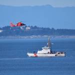 Kelley Balcomb-Bartok / Staff photo
US Coast Guard Cutter Swordfish stands by the scene of the vessel sinking as a Coast Guard helicopter flies overhead.