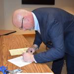 Kelley Balcomb-Bartok\ Staff photo
Newly Elected Sheriff Eric Peter signs official election paperwork during a ceremony Dec. 30 at the Superior Court courtroom.