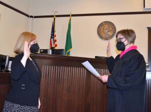 Kelley Balcomb-Bartok\ Staff photo
San Juan District Court Judge Carolyn M. Jewett officially returns to the bench following being sworn in by Superior Court Judge Kathryn Katie Loring Dec. 30.