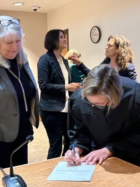Heather Spaulding \ Staff photo
Judge Katie Loring signs documents.