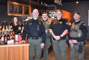 Kelley Balcomb-Bartok Staff photo
Sheriff Eric Peter is flanked by 13 Ravens Coffee owner Liberty Miller (left), and officers Nick Wainwright, Rion Brandt, and Jay Holt during the departments first Coffee With A Cop event held January 28 in Friday Harbor.